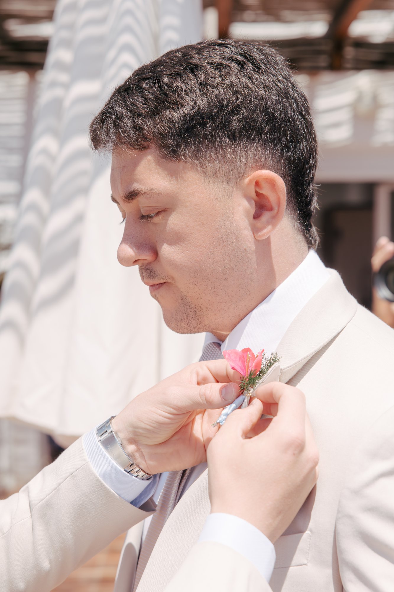 Groom getting his boutonniere, Agua Amarga, beach wedding