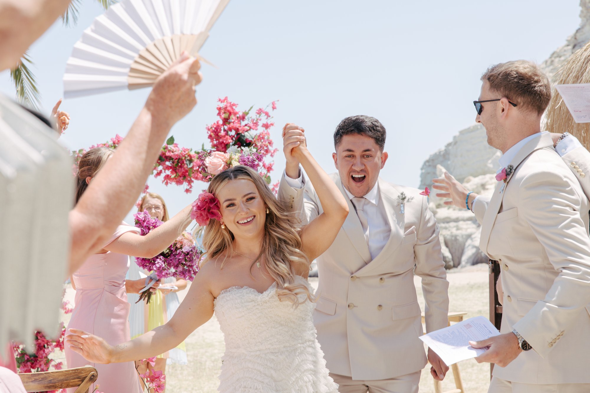Joyful recessional with fans after the ceremony, Agua Amarga, beach wedding