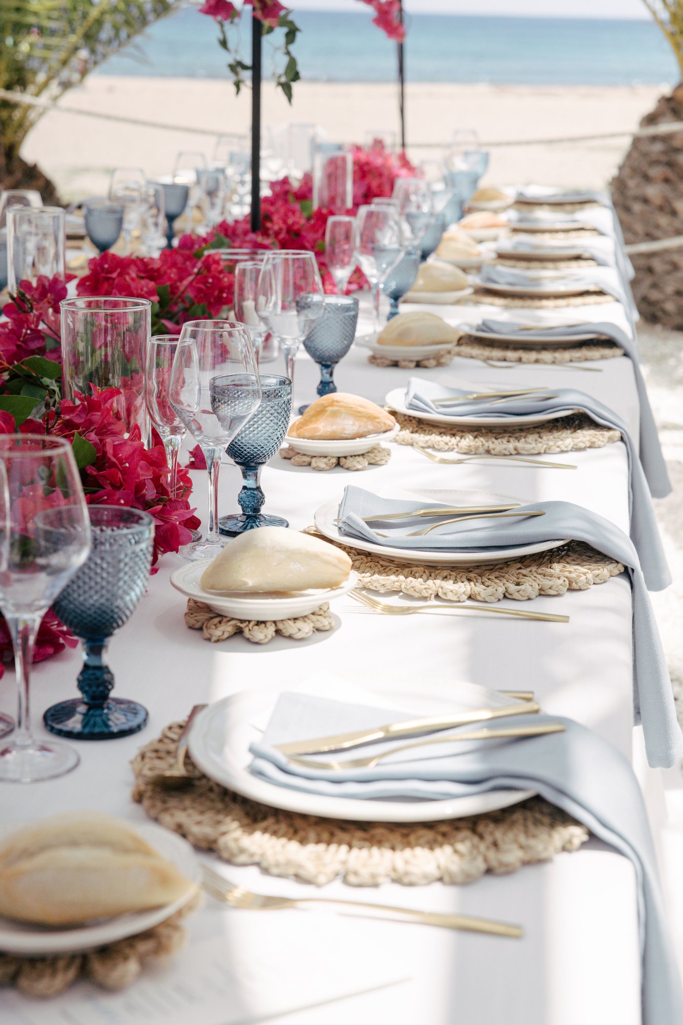 Wedding table with blue glasses and pink blooms, El Beach Agua Amarga, Mamma Mia wedding
