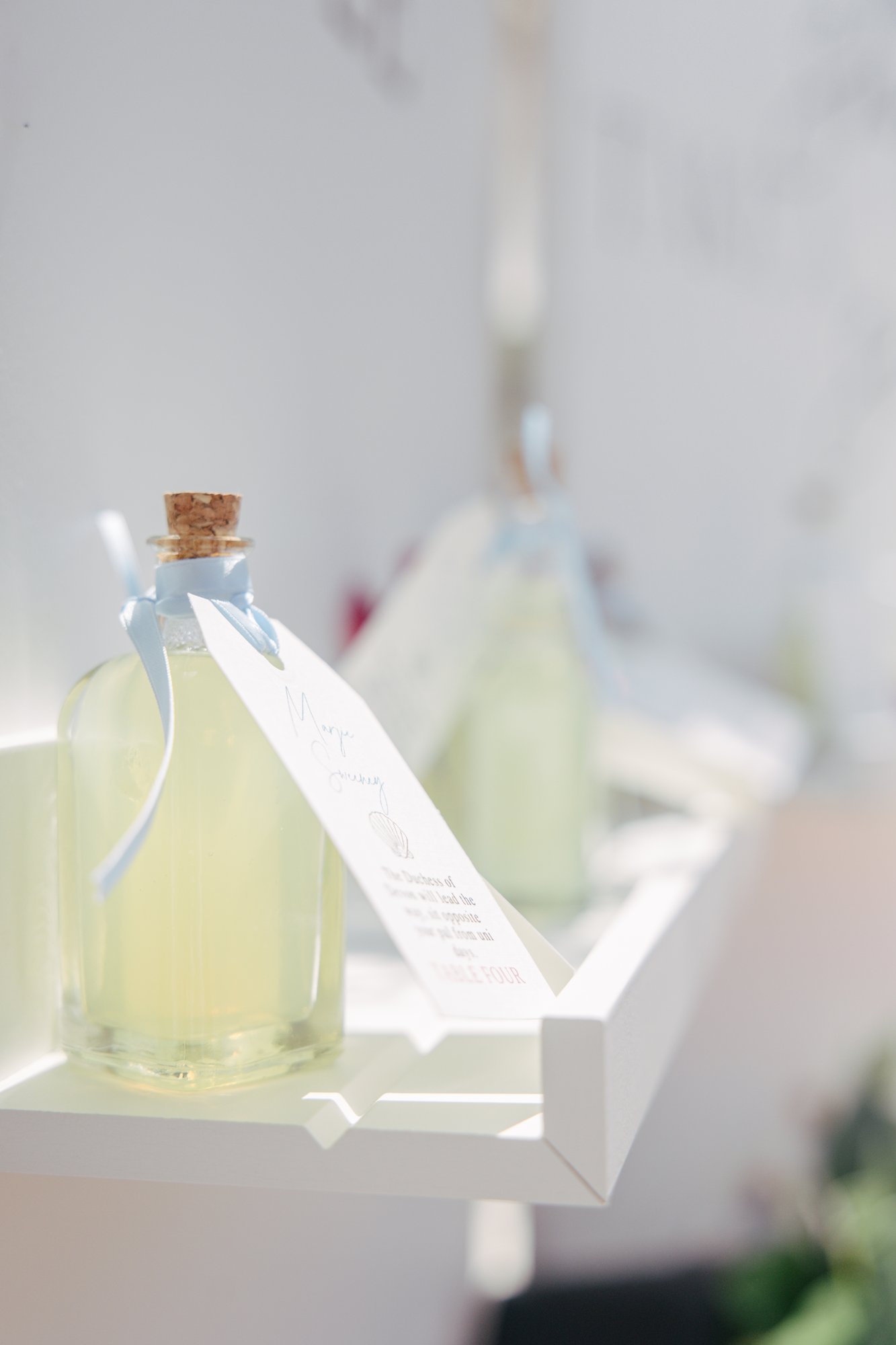 Limoncello bottles as the seating plan with quiz labels, Agua Amarga, Mamma Mia beach wedding