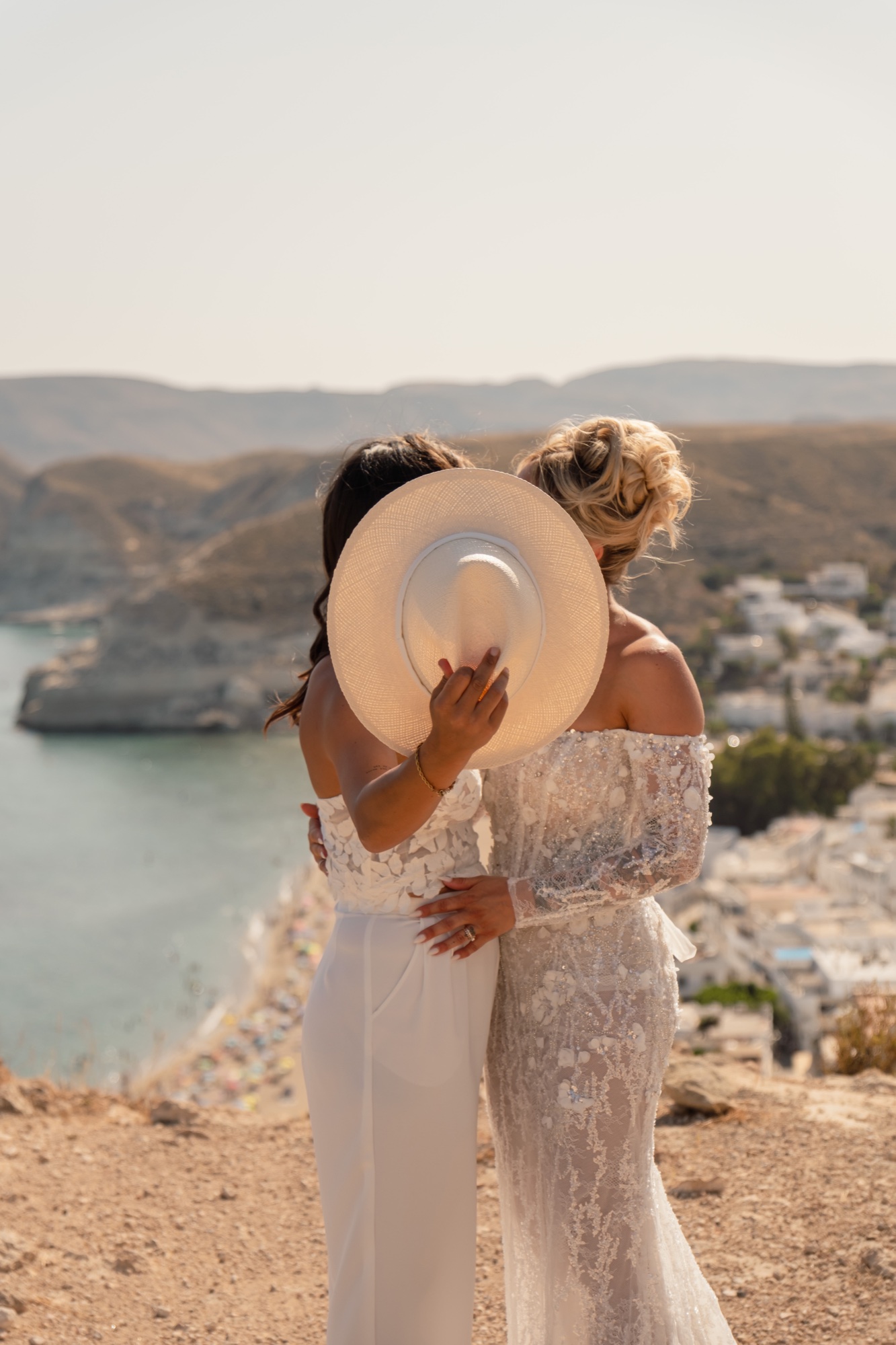 Two brides above the bay with the white village behind them, Agua Amarga Cabo de Gata, couple shoot