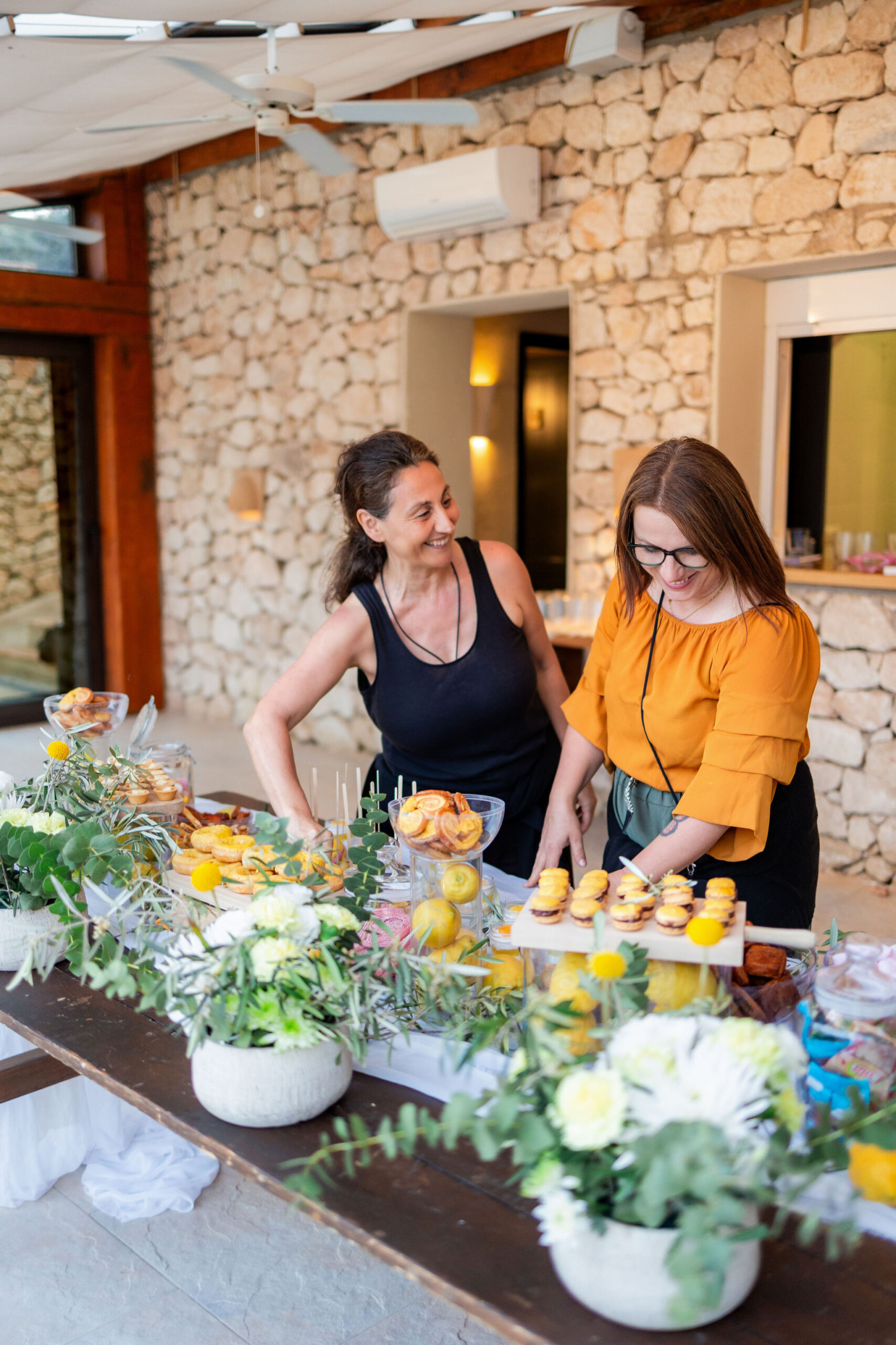 Hochzeitsplanerin und Catering bereiten das Dessertbuffet mit Zitronen-Süßigkeiten vor, Boho Strandhochzeit Cabo de Gata