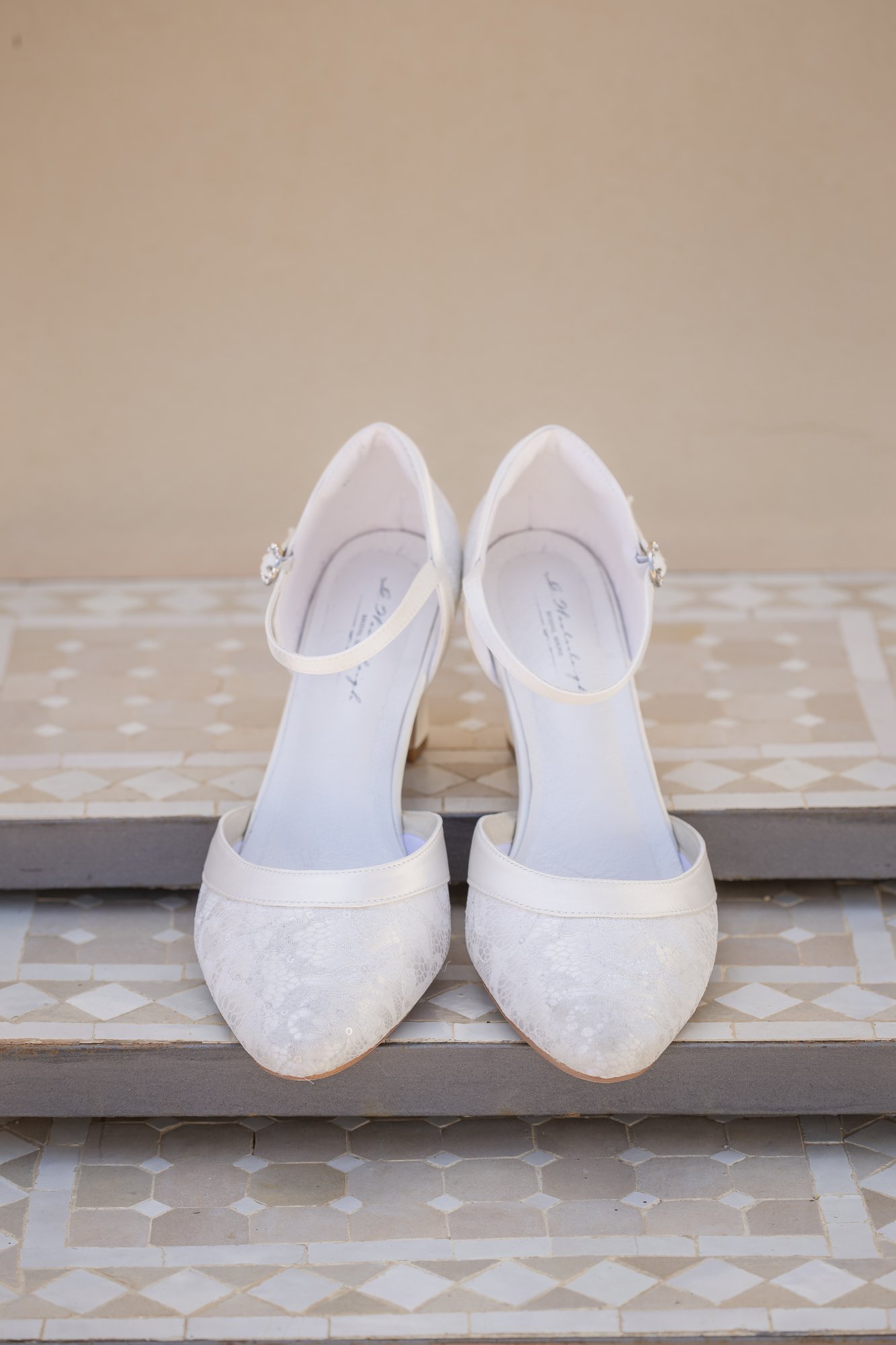 White bridal shoes on mosaic tiles, wedding Agua Amarga, boho wedding
