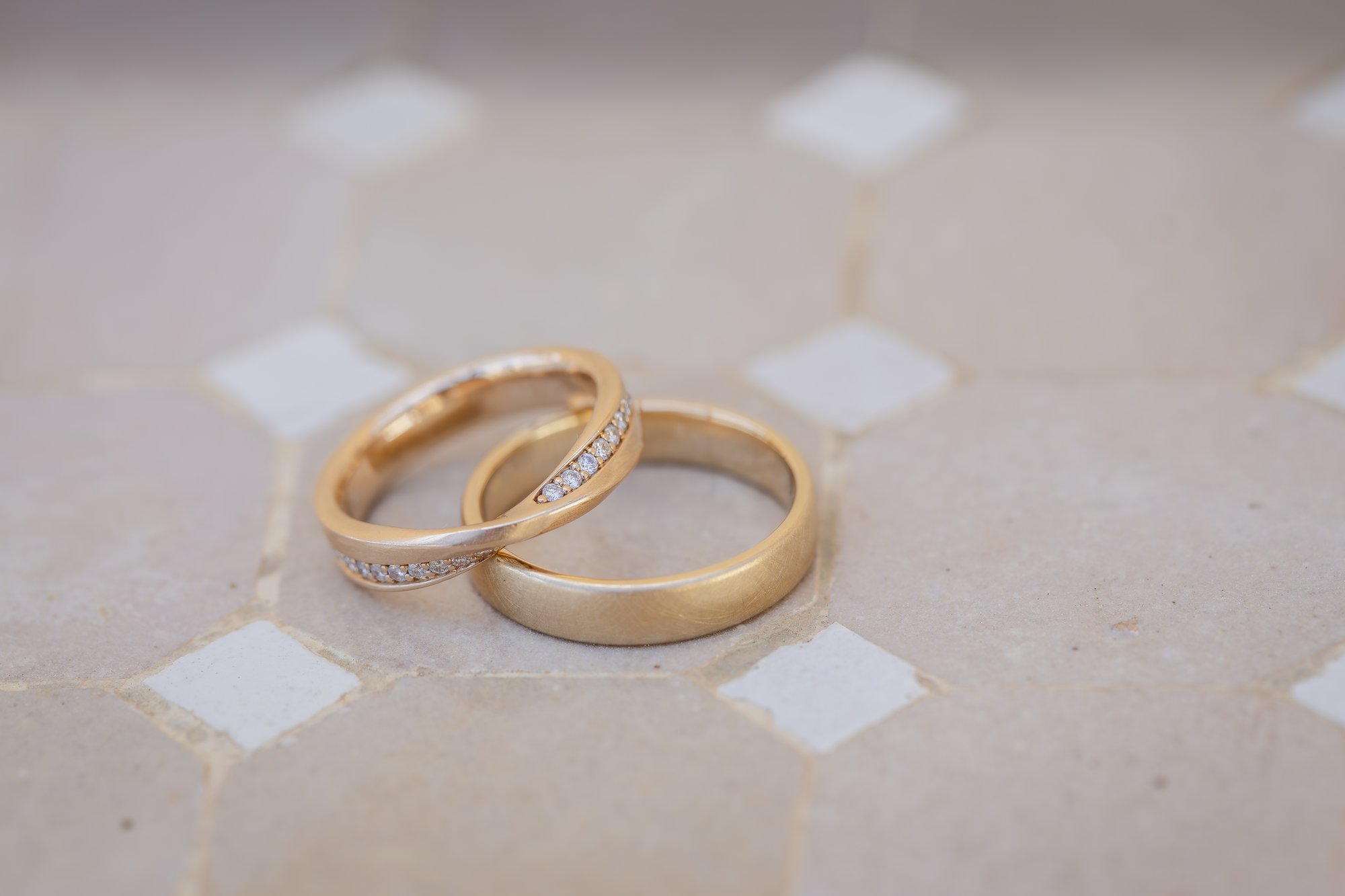 Gold wedding rings on light tiles, wedding Agua Amarga