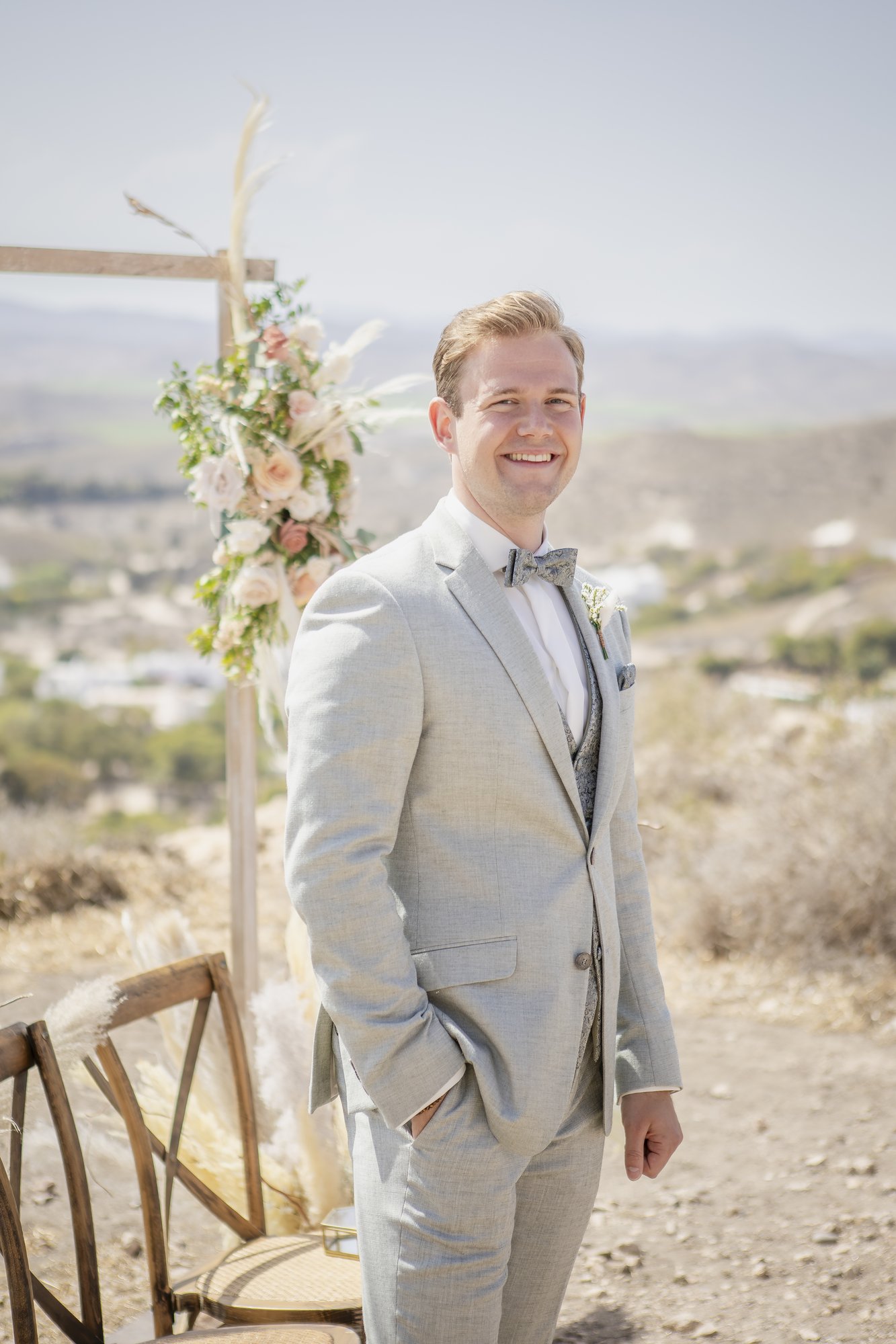 Groom waiting at the ceremony arch, outdoor ceremony, wedding Agua Amarga