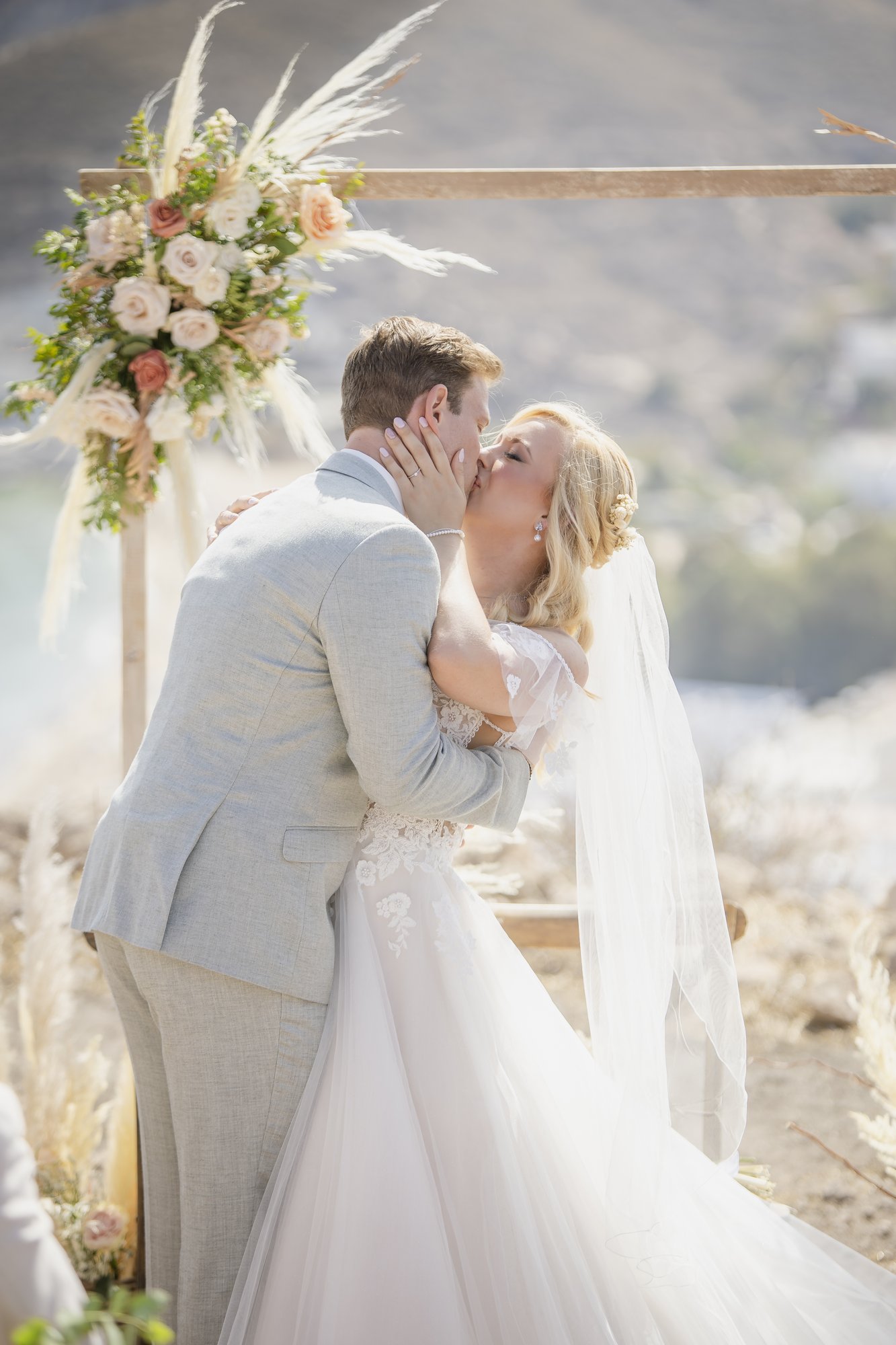 First kiss at the ceremony arch, outdoor ceremony, wedding Agua Amarga
