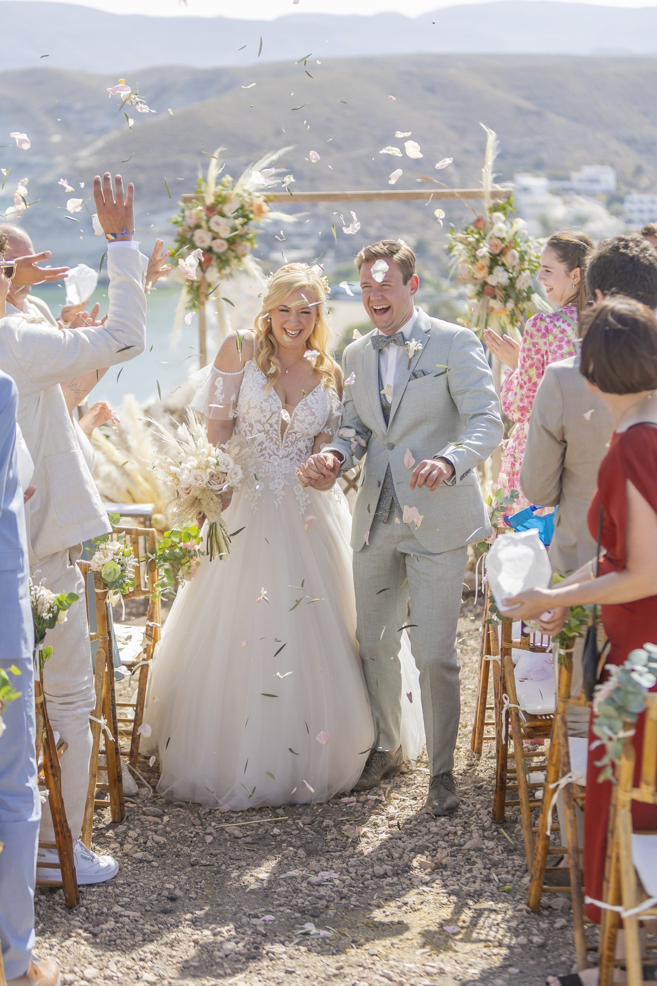 Couple walking back down the aisle under confetti, wedding Agua Amarga