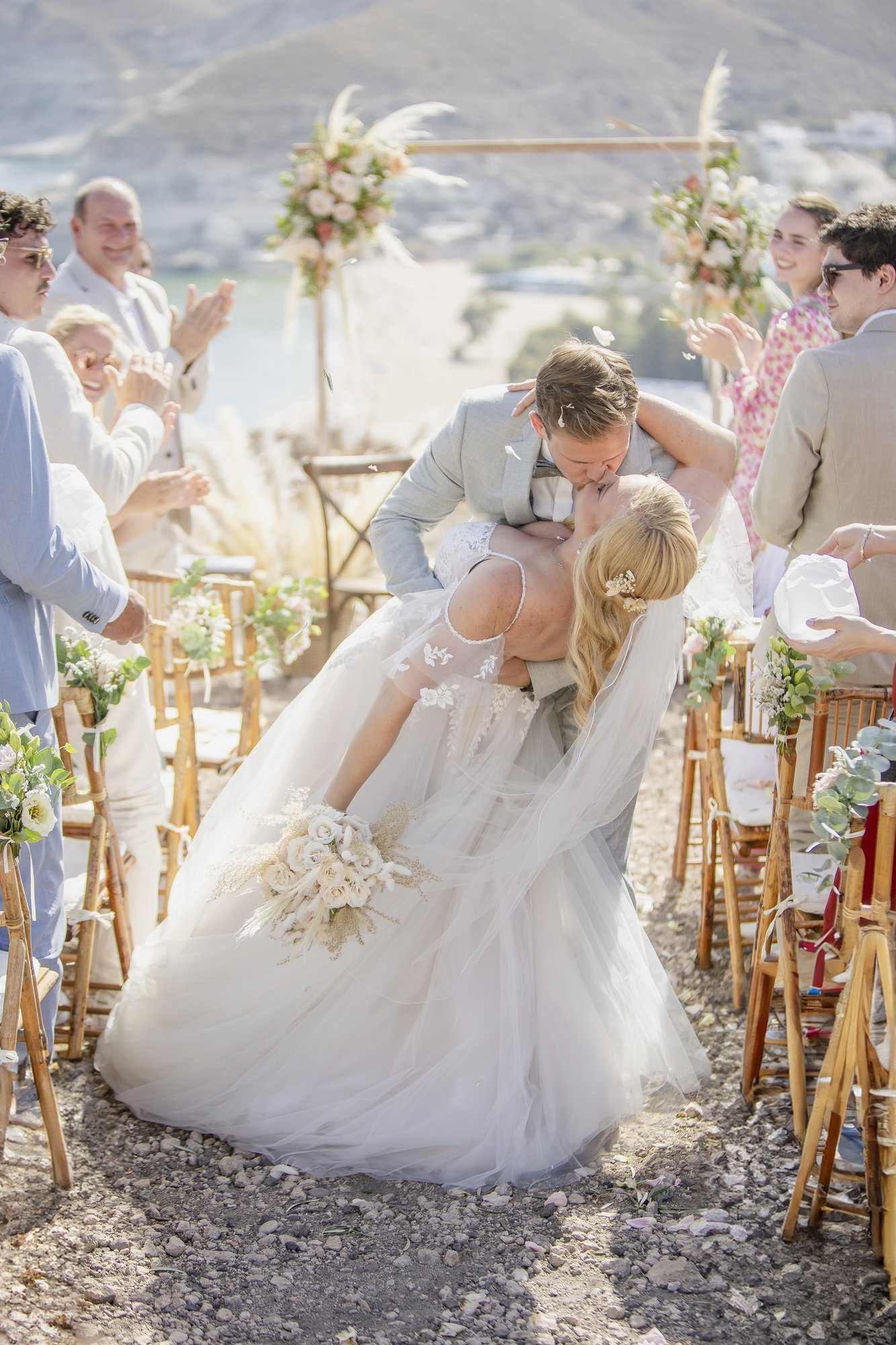 Kiss in the aisle while guests applaud, wedding Agua Amarga