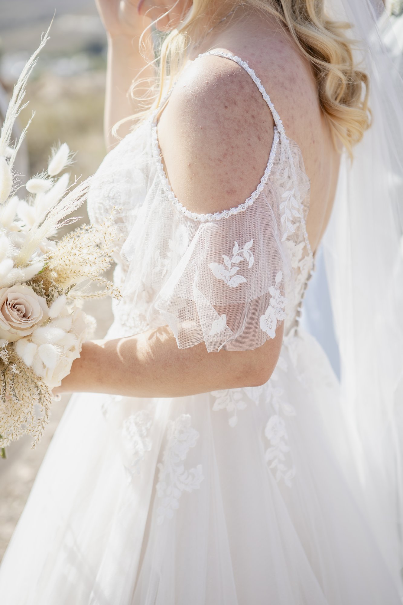 Detail of the wedding dress with lace sleeves, boho wedding Agua Amarga