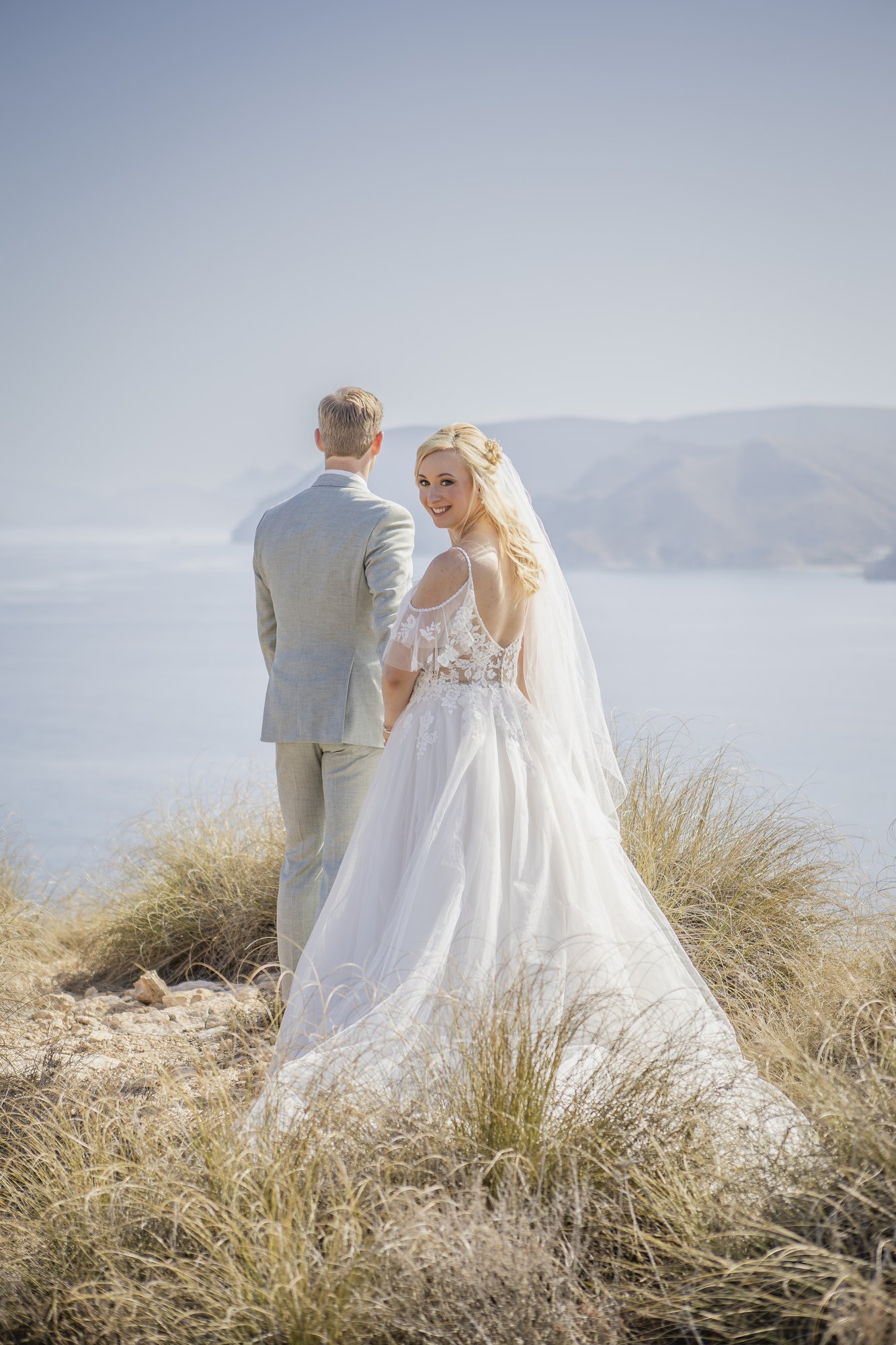 Couple seen from behind above the cliffs, wedding Agua Amarga