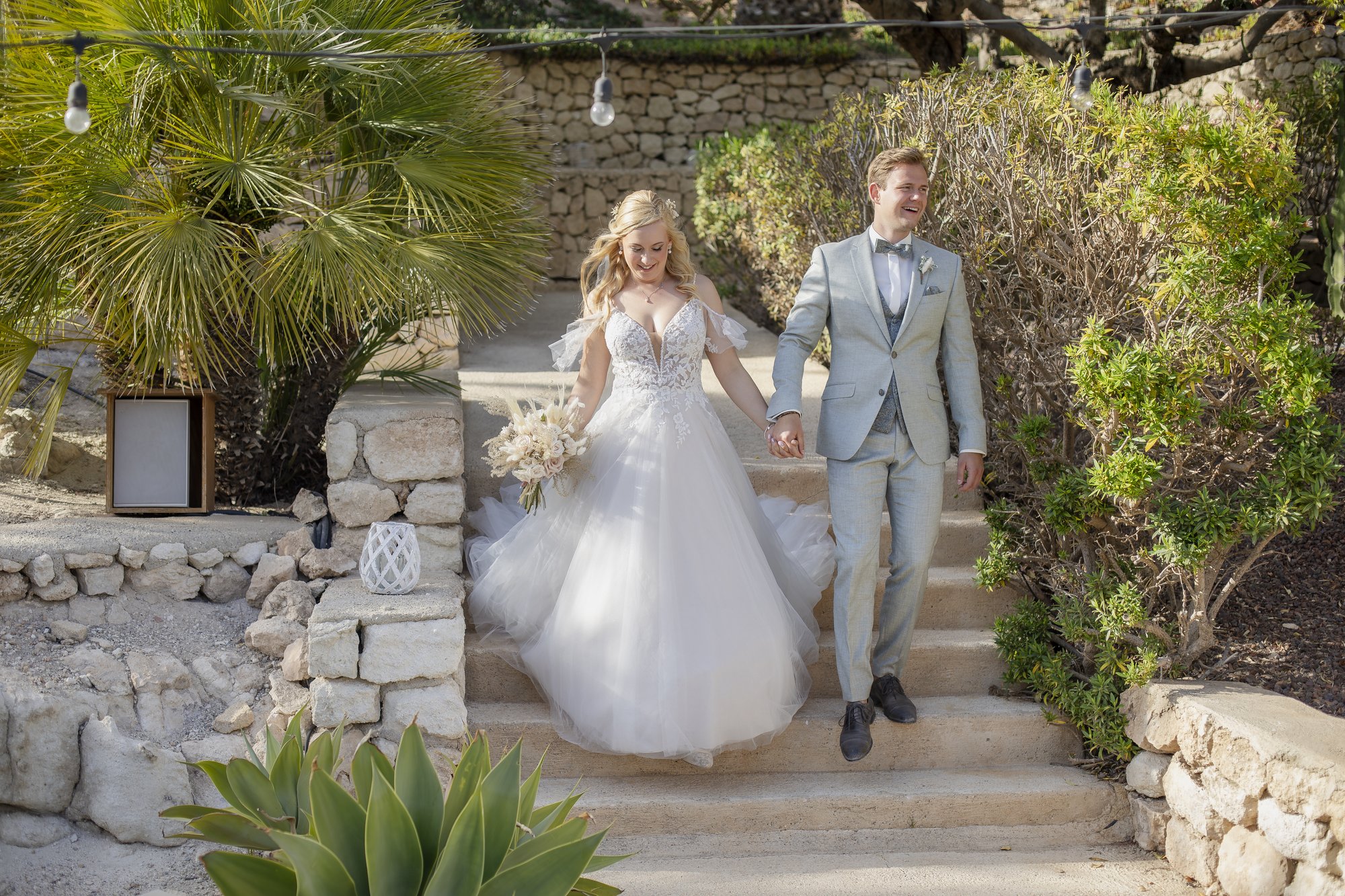 Couple arriving down the steps of the hotel garden, wedding Agua Amarga