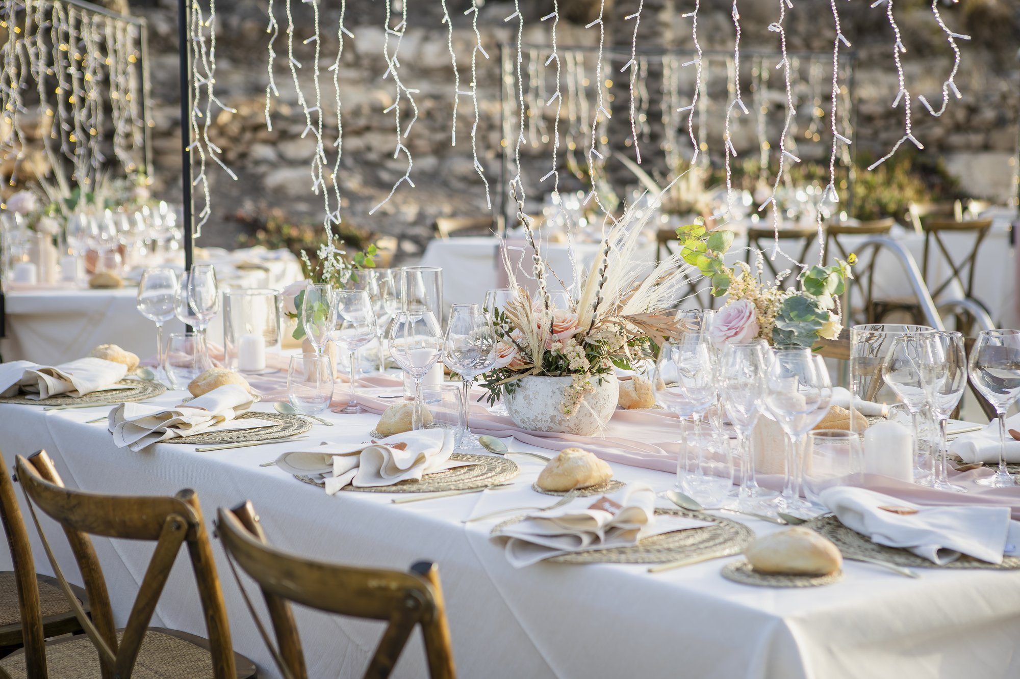 Long table under fairy light curtains, dinner, wedding Agua Amarga