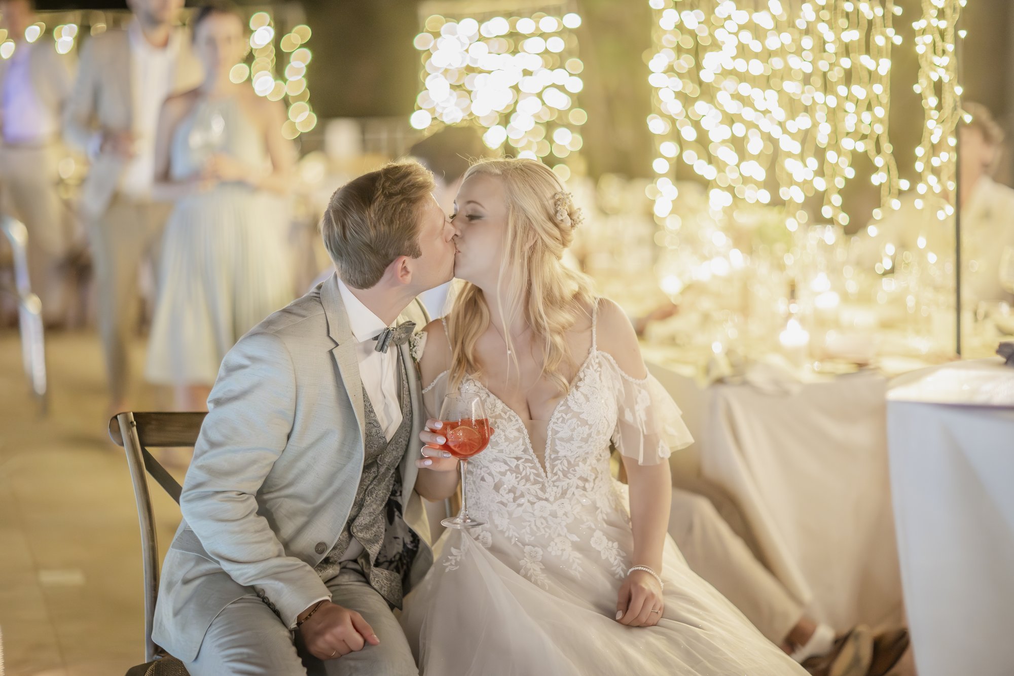 Couple kissing in the evening under fairy lights, wedding Agua Amarga